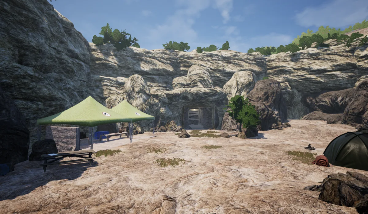 An early virtual environment with a rocky landscape, tents, trees and a cave entrance.